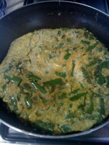 Flipped frittata goes from plate back into pan to cook other side